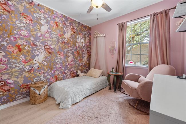The fourth bedroom boasts a gorgeous modern wallpaper feature wall. | Image 21