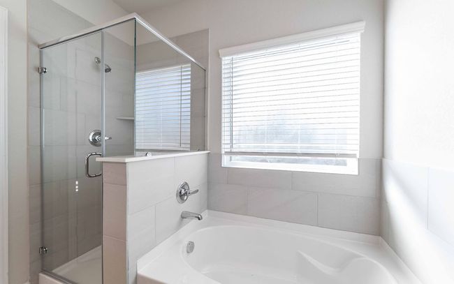 Bathroom featuring a bath and a shower stall | Image 17