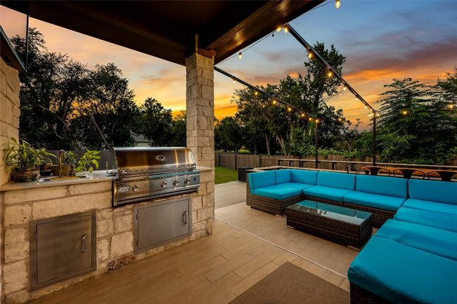 Outdoor kitchen with propane grill and sink. | Image 33