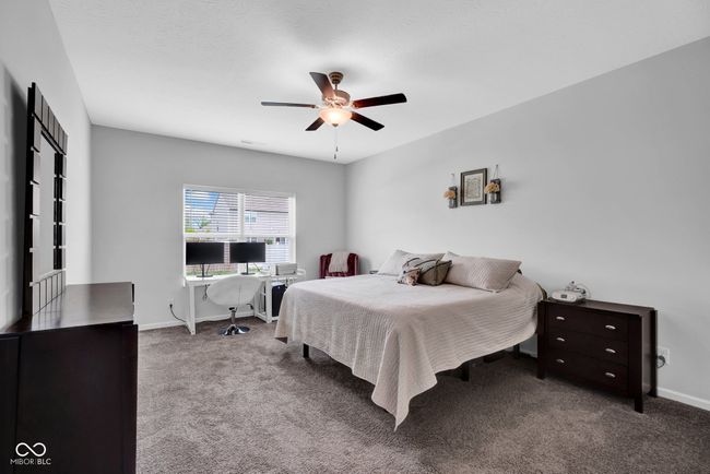 carpeted bedroom featuring baseboards and ceiling fan | Image 17