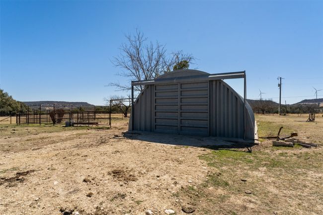 View of outdoor structure with a rural view, an outdoor structure, fence, and dirt driveway | Image 18