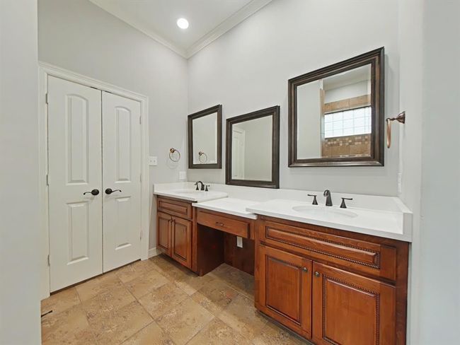 Elegant primary bath with a spacious double-sink vanity, newly installed quartz countertops and new sinks. | Image 19