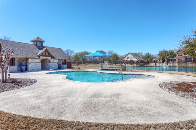 Pool with a patio area and fence | Image 37