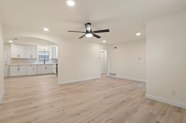 Laundry area featuring washer hookup, hookup for an electric dryer, baseboards, and light wood-style flooring | Image 18