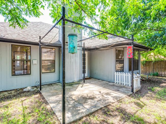 Back of house with roof with shingles and a patio | Image 7