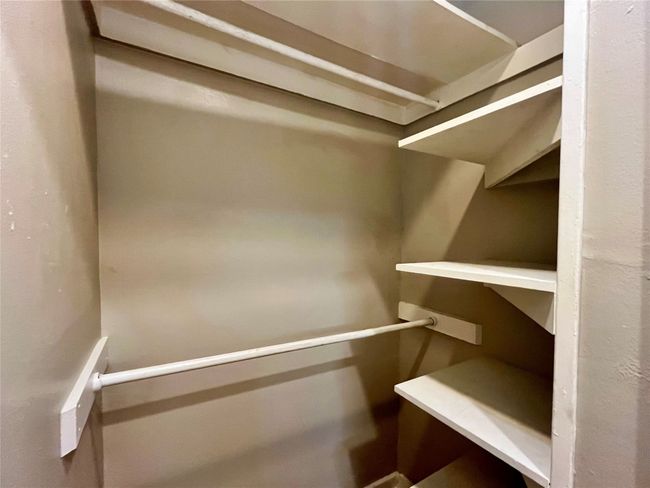 Here is a nice closet with places to hold hanging clothes and folded clothing. | Image 8