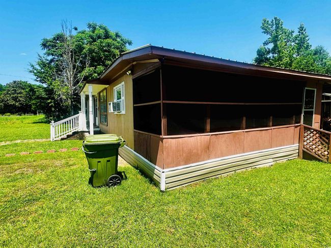 View of property exterior with a lawn and cooling unit | Image 21