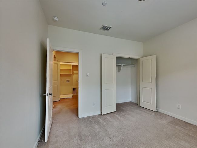 Unfurnished bedroom with carpet floors, baseboards, and a closet | Image 9