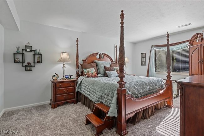 Bedroom with visible vents, baseboards, and light carpet | Image 16