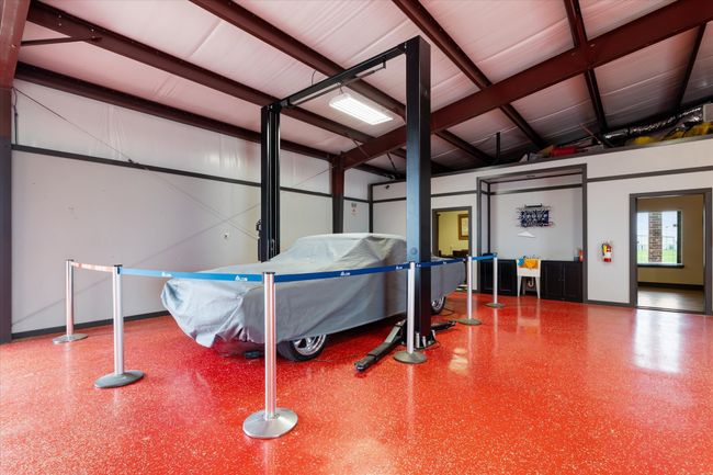 Garage with baseboards | Image 21