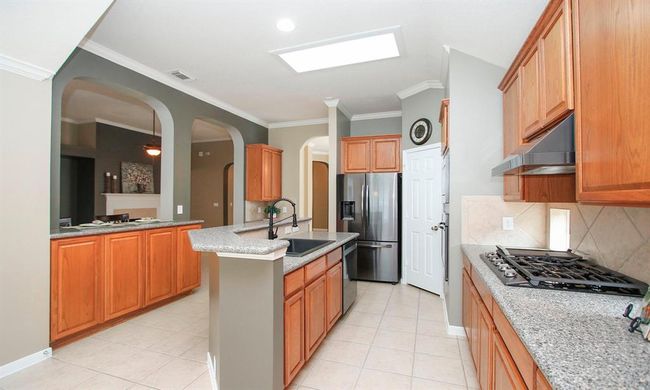 With an abundance of counter space, this kitchen provides plenty of prep space for any chef! Refrigerator included. | Image 14
