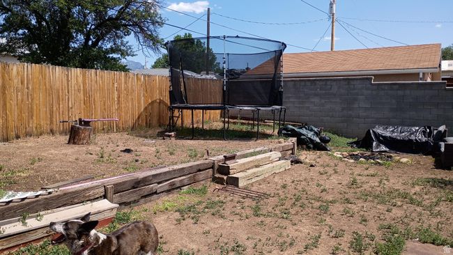 Fenced backyard with a trampoline | Image 37