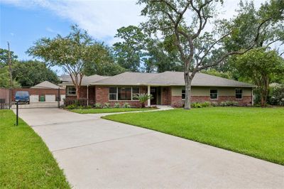 The extended driveway offers ample parking for family and guests. An automatic gate leads to the two-car garage with extra parking space. All windows in the home have been upgraded to energy-efficient double-pane windows. | Image 2