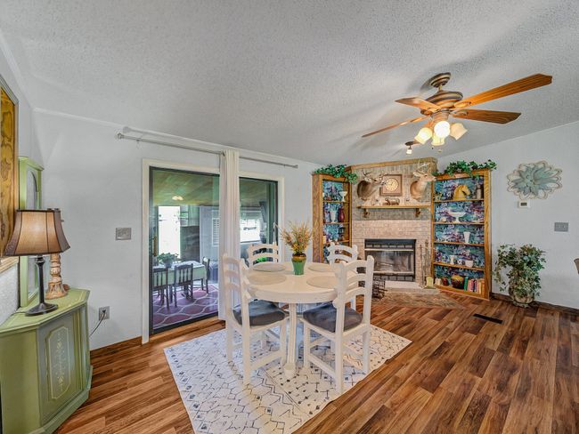 Dining area featuring a fireplace, house one. | Image 8