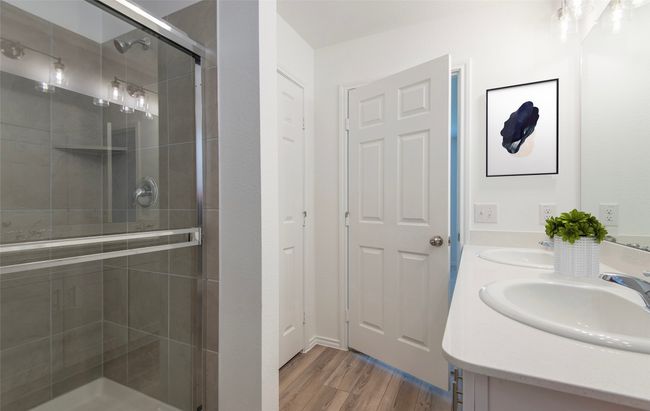 Owner's bath with large shower and double vanity *Photos of furnished model. Not actual home. Representative of floor plan. Some options and features may vary | Image 9