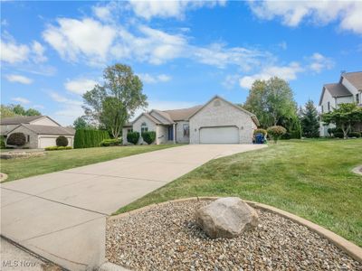 Single story home with a garage and a front lawn | Image 2