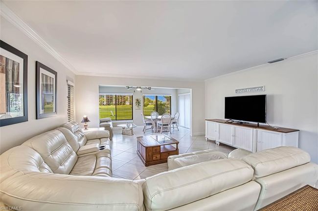 Living area featuring crown molding and light tile patterned floors | Image 11
