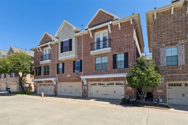 View of property featuring brick siding and an attached garage | Image 18