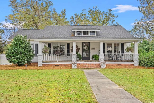 View of front of property featuring a porch, a front yard, and roof with shingles | Image 39