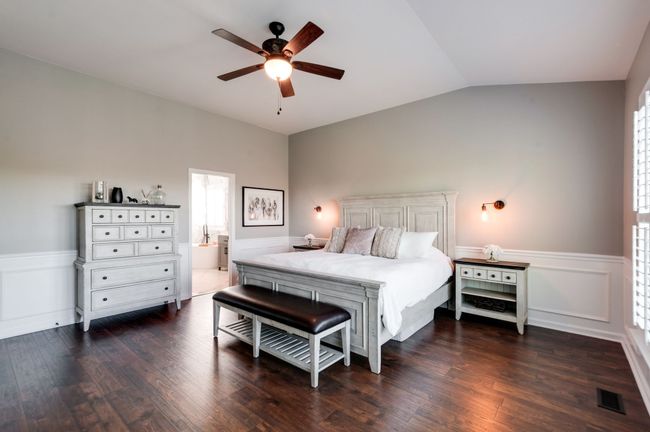 The primary bedroom has the same lovely floors found throughout the main floor and offers ample space to accommodate a king sized bed and plenty of furniture | Image 26
