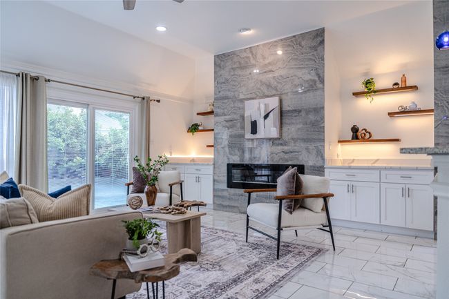 Living room featuring light marble finish floors, a premium fireplace, ceiling fan, and recessed lighting | Image 20