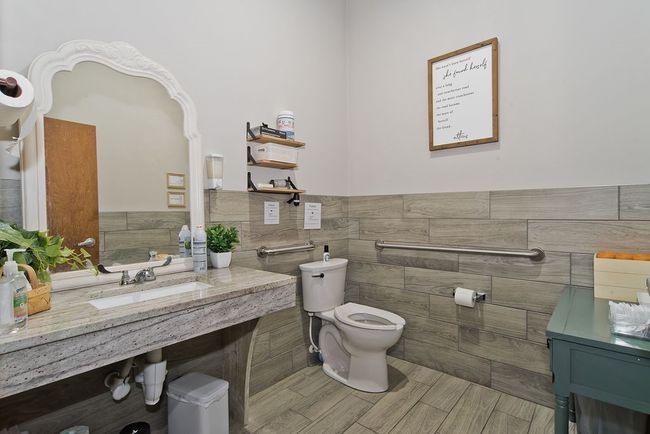Bathroom featuring tile walls and wainscoting | Image 20