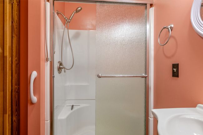 Bathroom featuring a shower stall and a sink | Image 45