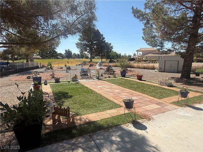 View of grassy yard featuring a storage unit | Image 57