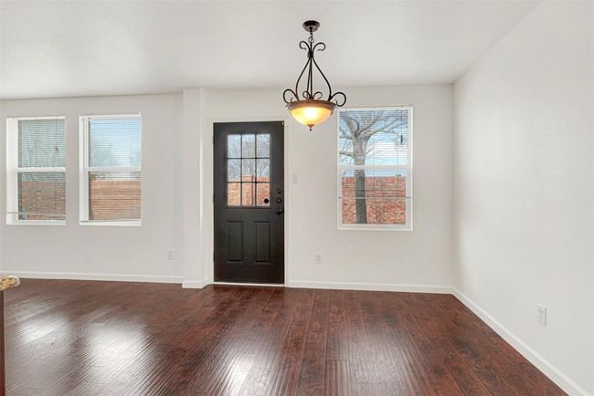 Entryway featuring dark wood-style flooring, healthy amount of natural light, and baseboards | Image 5