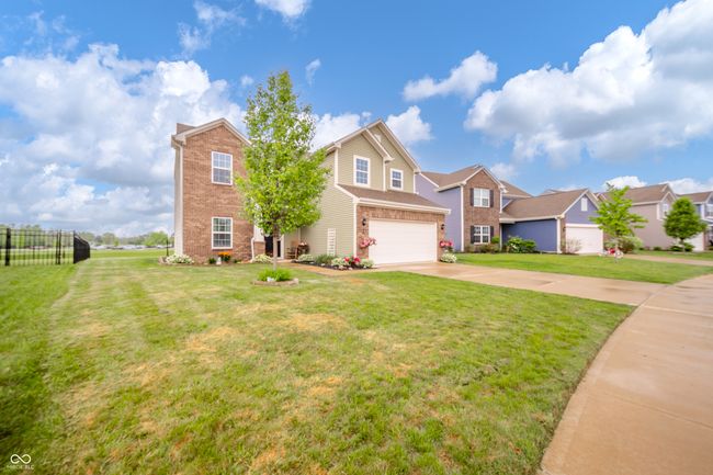 traditional-style home with a garage, brick siding, and concrete driveway | Image 4