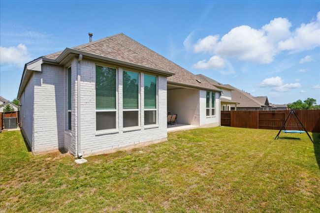 Back of property with brick siding, a patio area, a shingled roof, and cooling unit | Image 33