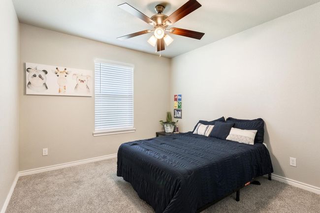 Carpeted bedroom with baseboards and a ceiling fan | Image 24