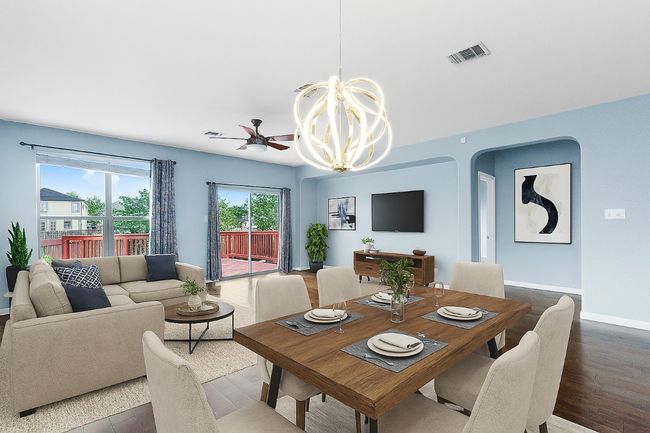 Dining area with wood finished floors, arched walkways, ceiling fan, and a chandelier | Image 9