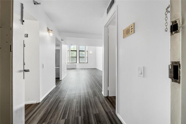 Corridor with dark wood-style flooring and baseboards | Image 6