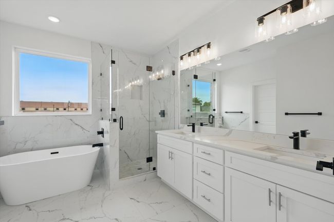Full bathroom with double vanity, a marble finish shower, a soaking tub, marble finish floors, and recessed lighting | Image 25