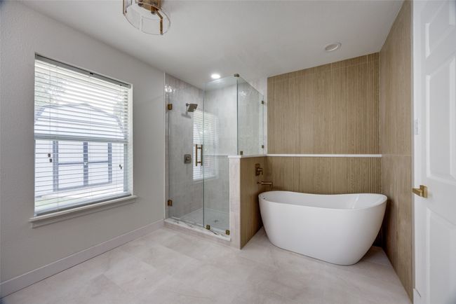 Bathroom with a shower stall and a freestanding tub | Image 20