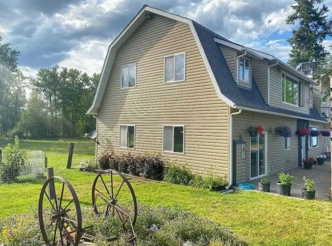 View of side of home with a lawn, a patio, a shingled roof, and a gambrel roof | Image 4