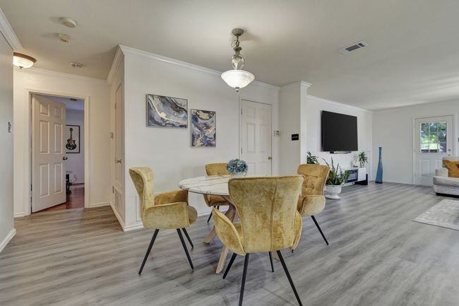 Dining room featuring ornamental molding and wood-type flooring | Image 11