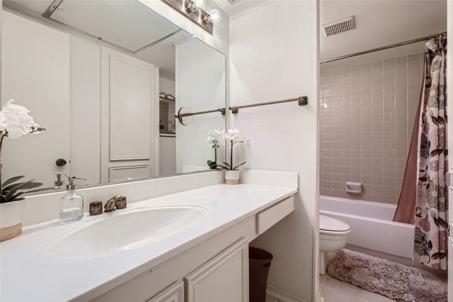 Bathroom with vanity, toilet, shower / tub combo with curtain, and tile patterned flooring | Image 20