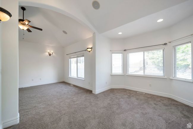 Primary bedroom with vaulted ceilings and a sitting area | Image 15