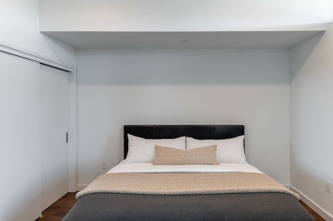 Bedroom with dark wood-style floors and a closet | Image 18