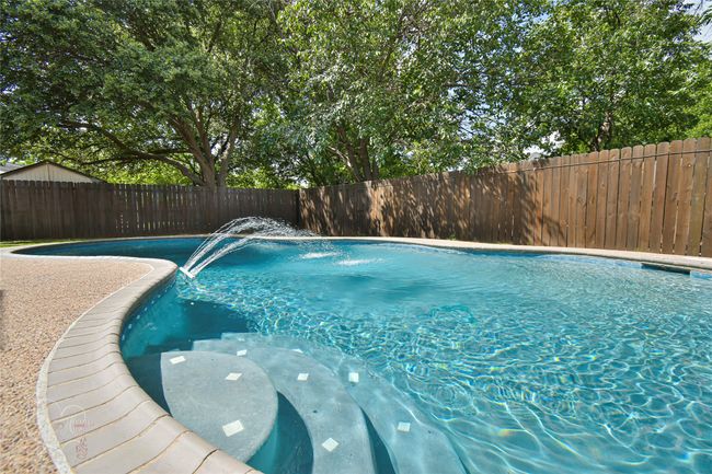 View of pool featuring a fenced backyard | Image 6