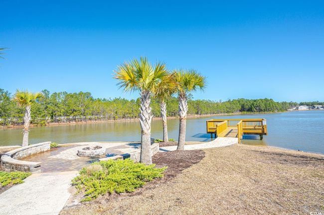Dock area featuring an outdoor fire pit, a water view, and a boat ramp | Image 38