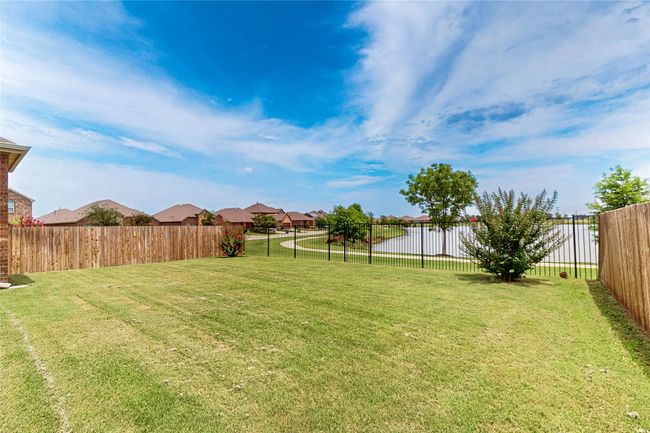 Fenced backyard with a residential view | Image 39