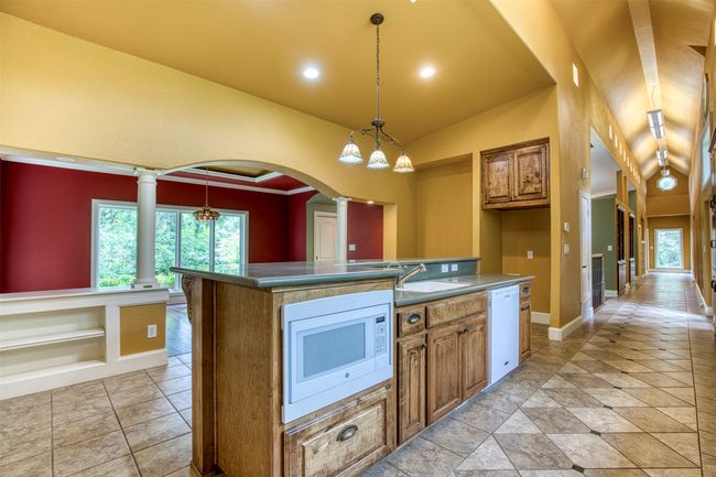 Kitchen features large eat-in island with storage. | Image 13