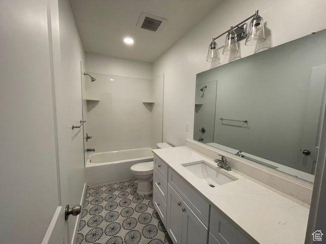 Full bathroom featuring tub / shower combination, vanity, and toilet | Image 22