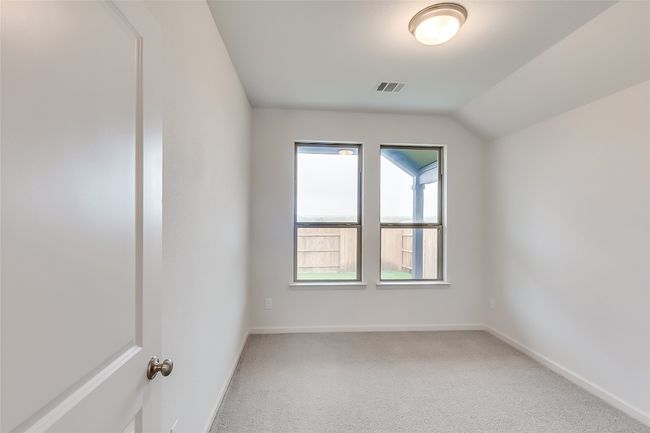 Carpeted empty room featuring baseboards and lofted ceiling | Image 21
