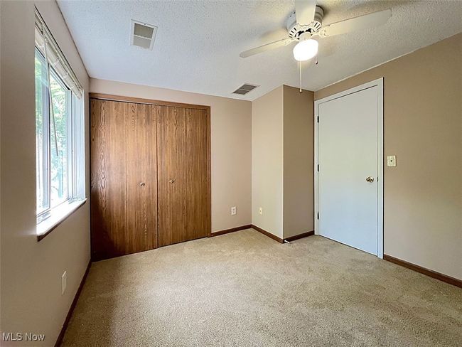 Third bedroom with a closet, carpet floors, a textured ceiling, and ceiling fan | Image 17