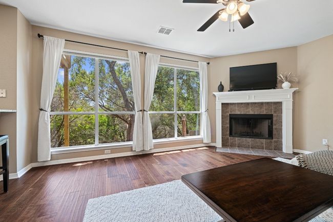 Whether you're enjoying a quiet night in or gathering with friends, the living room’s expansive windows and tree-filled backdrop make it a space you’ll never want to leave | Image 10