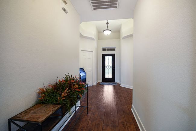 Doorway featuring dark wood-type flooring and baseboards | Image 4